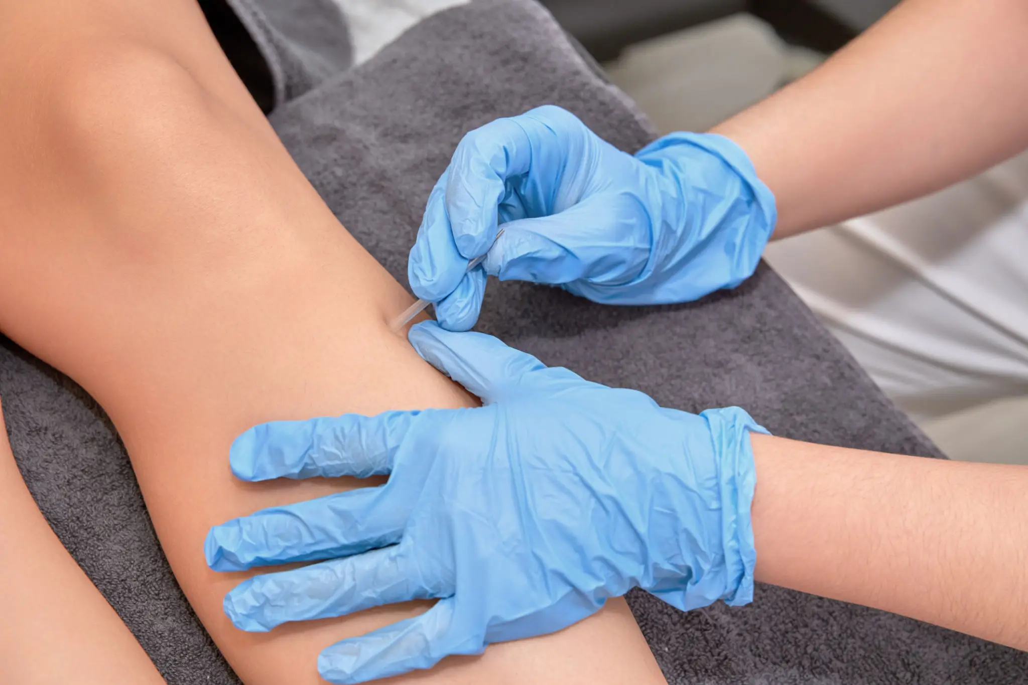 Healthcare professional administering an injection to a patient's arm.